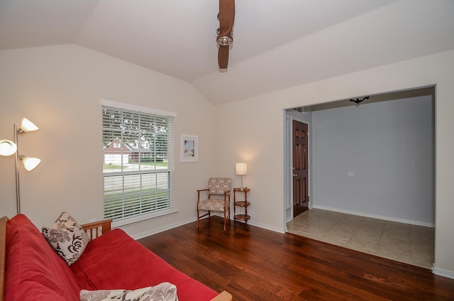 living room with dark hardwood / wood-style flooring and vaulted ceiling