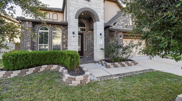 property entrance with a garage and a lawn