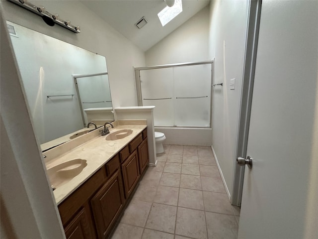 full bathroom featuring combined bath / shower with glass door, lofted ceiling with skylight, vanity, tile patterned floors, and toilet