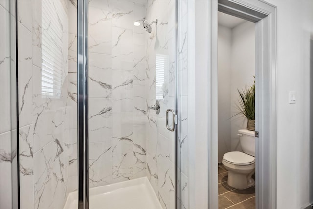 bathroom featuring toilet and walk in shower