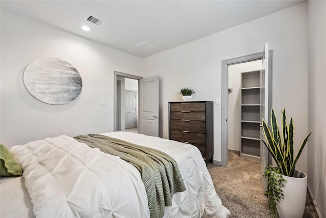 bedroom featuring a spacious closet and carpet