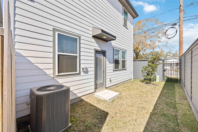 exterior space featuring cooling unit and a lawn