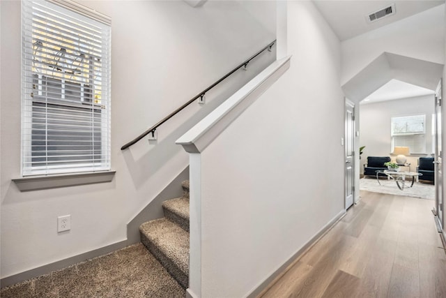 stairway with hardwood / wood-style flooring