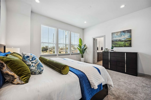 bedroom with carpet floors and ensuite bath