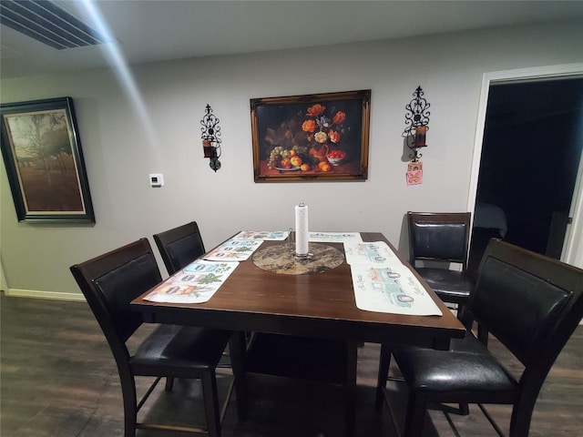 dining space with dark hardwood / wood-style floors