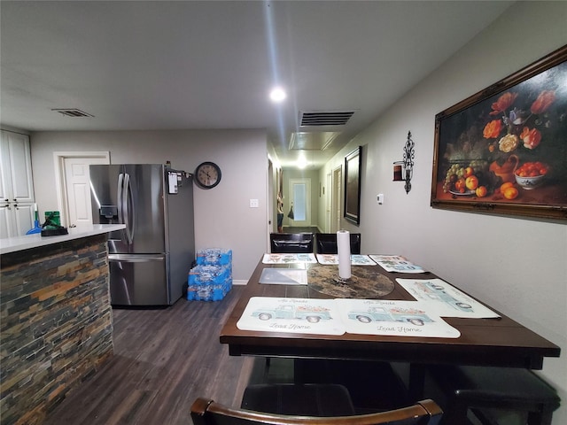 dining space with dark hardwood / wood-style flooring