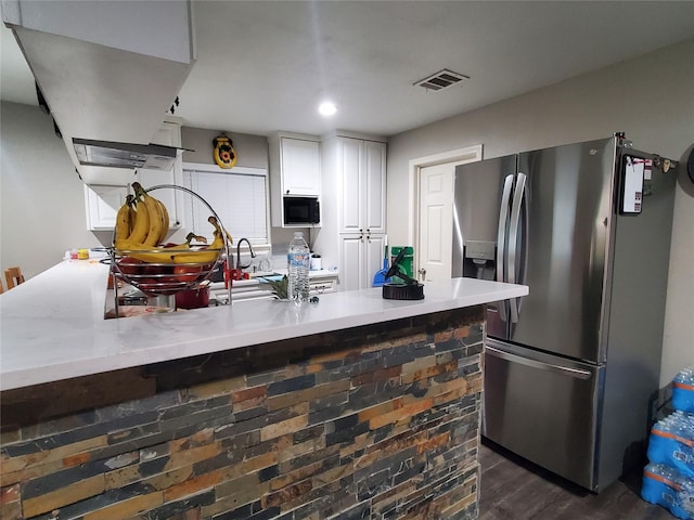 kitchen with stainless steel refrigerator with ice dispenser, white cabinetry, and dark wood-type flooring