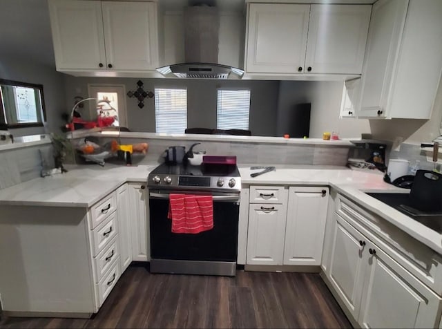 kitchen featuring white cabinetry, stainless steel electric stove, kitchen peninsula, and wall chimney exhaust hood