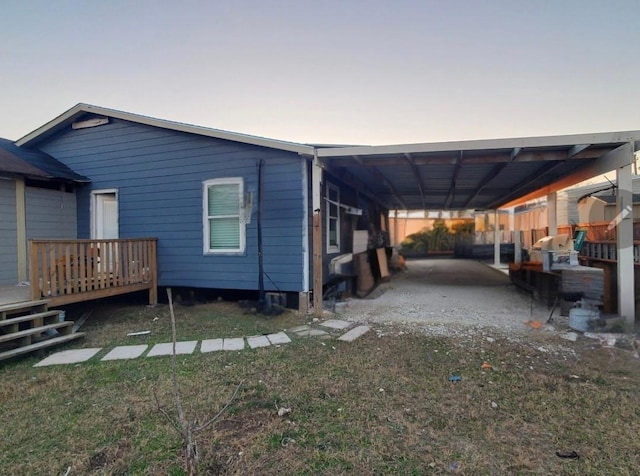 property exterior at dusk featuring a carport