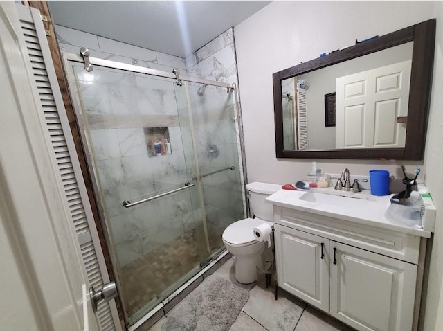 bathroom featuring a shower with door, vanity, and toilet