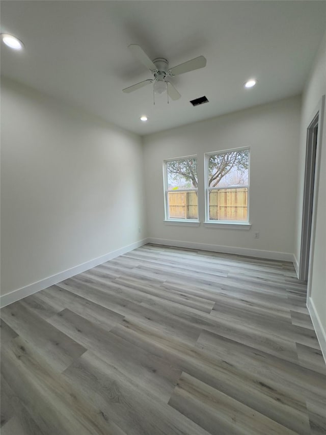 spare room featuring ceiling fan and light hardwood / wood-style floors