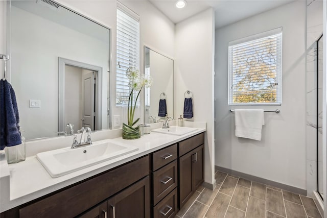 bathroom featuring vanity and a shower with door