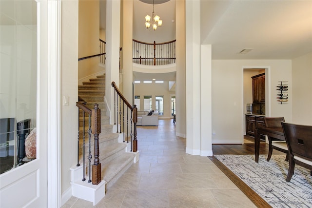 foyer featuring a chandelier and a high ceiling