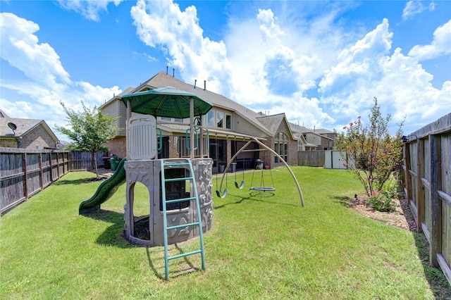 view of yard with a storage shed and a playground