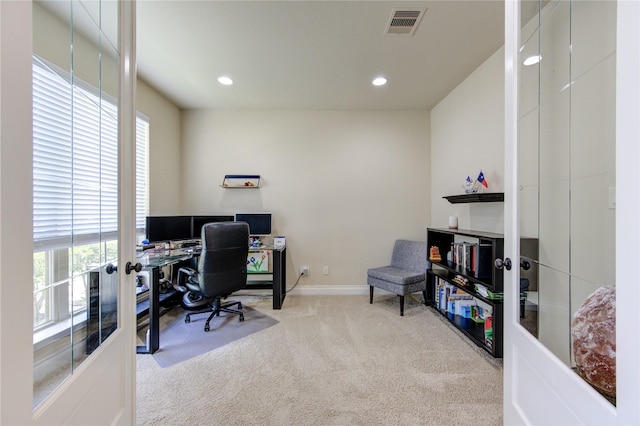 carpeted home office featuring french doors