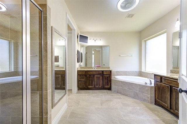 bathroom with shower with separate bathtub and vanity