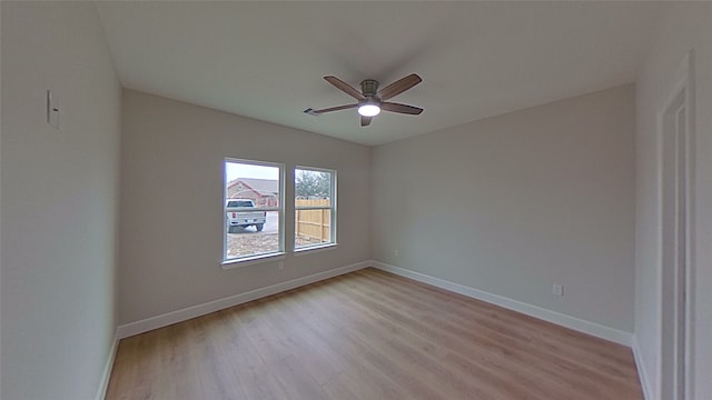 empty room featuring ceiling fan and light hardwood / wood-style flooring