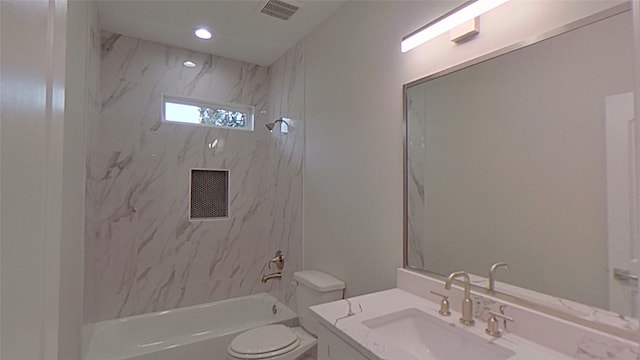 full bathroom with vanity, tiled shower / bath combo, and toilet