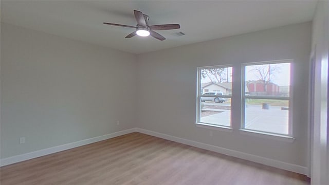 empty room with ceiling fan and light wood-type flooring