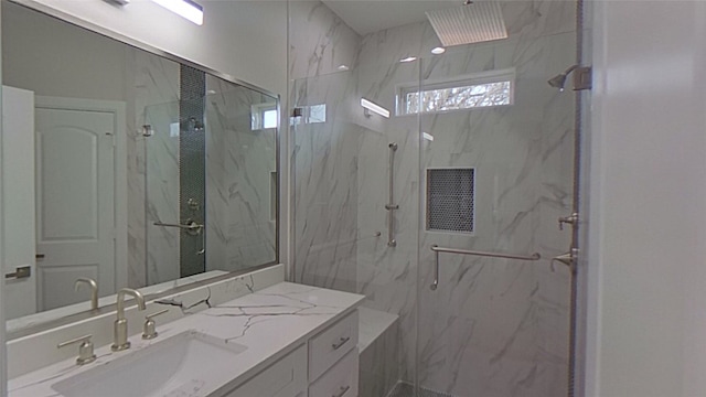 bathroom featuring vanity and a shower with door