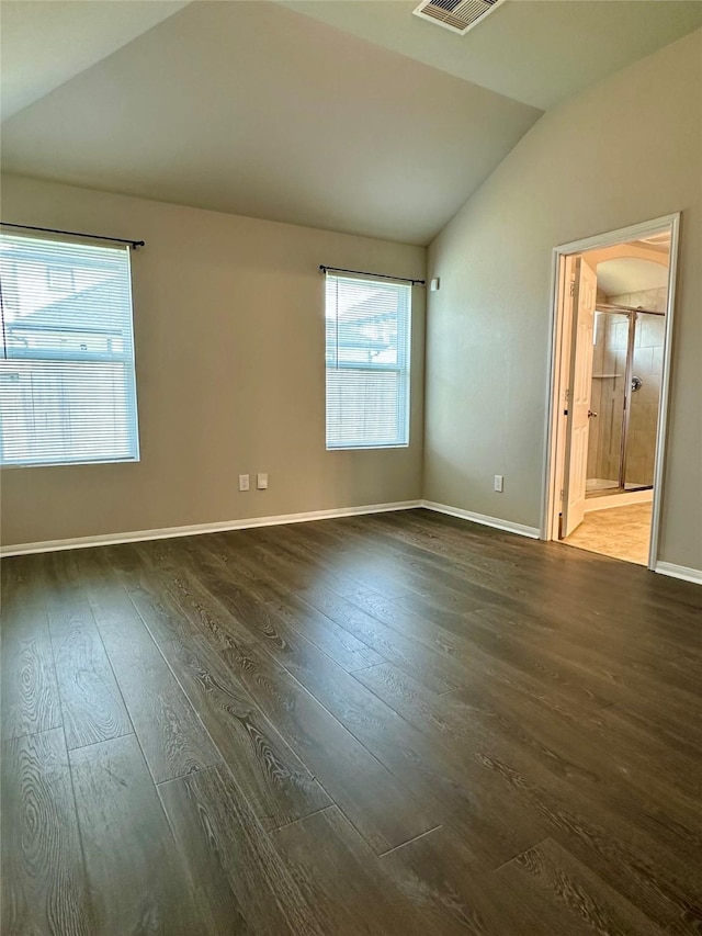 unfurnished room with dark hardwood / wood-style flooring and vaulted ceiling