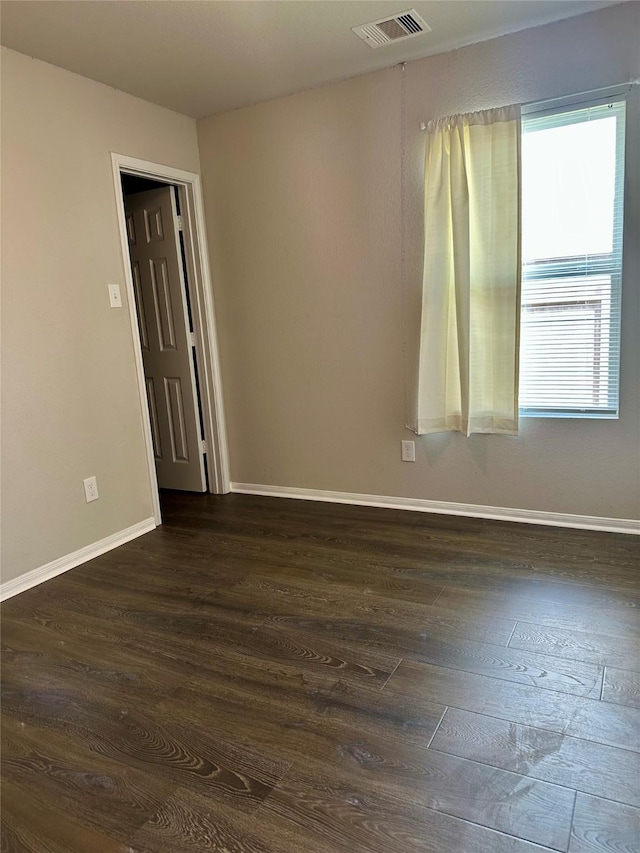 spare room featuring dark hardwood / wood-style flooring