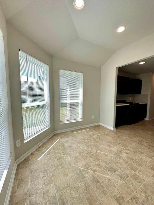 unfurnished living room with vaulted ceiling