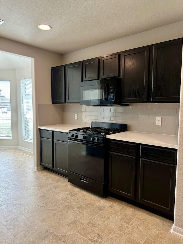 kitchen with tasteful backsplash, a textured ceiling, and black appliances