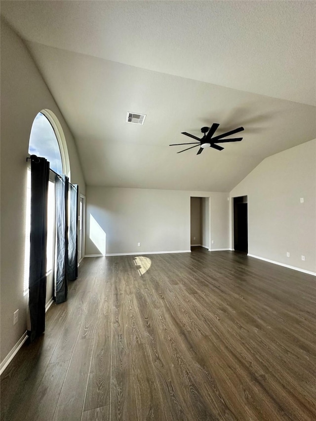 unfurnished living room with vaulted ceiling, dark hardwood / wood-style floors, and ceiling fan