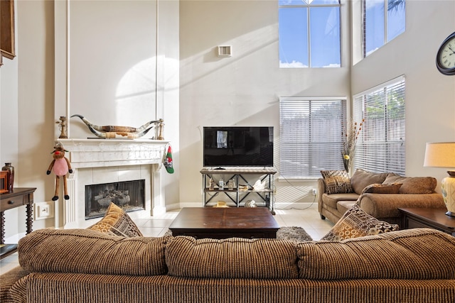 living room with light tile patterned floors and a towering ceiling