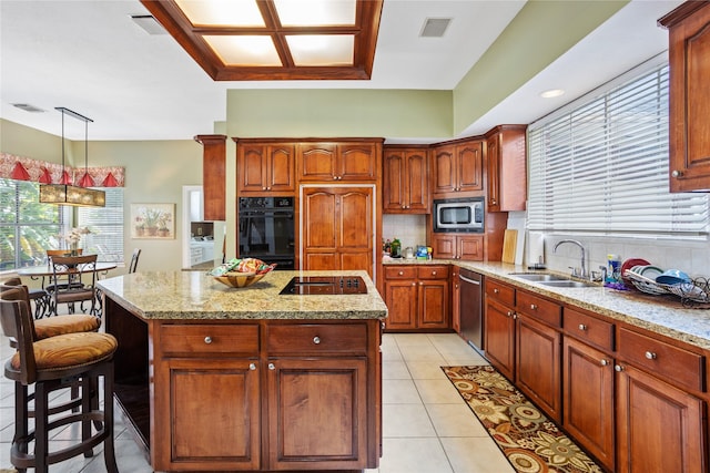 kitchen with a kitchen island, sink, backsplash, hanging light fixtures, and black appliances