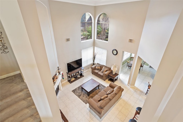 living room featuring a towering ceiling and light tile patterned flooring