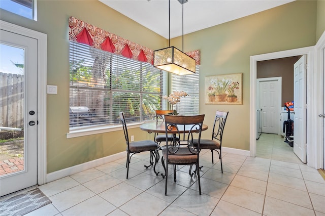 dining area with a wealth of natural light and light tile patterned floors