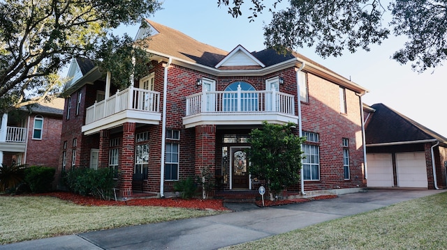 view of front of house featuring a balcony, a garage, and a front lawn