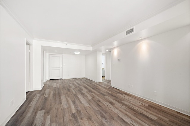 spare room with crown molding and hardwood / wood-style flooring