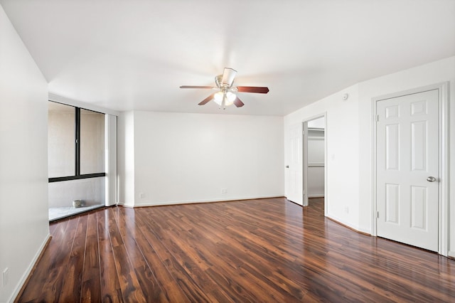 spare room featuring ceiling fan and dark hardwood / wood-style flooring