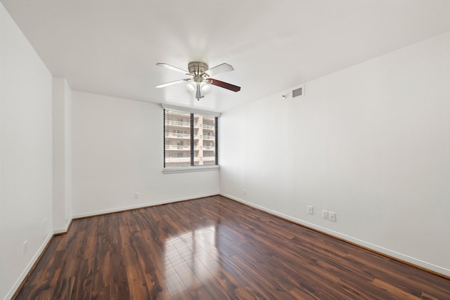 spare room featuring ceiling fan and dark hardwood / wood-style flooring