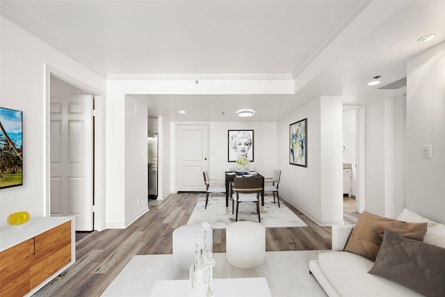 living room with hardwood / wood-style flooring and crown molding