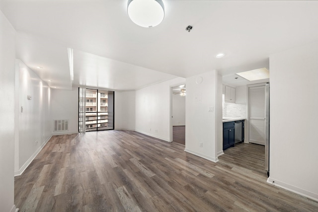 unfurnished living room featuring dark hardwood / wood-style floors and ceiling fan