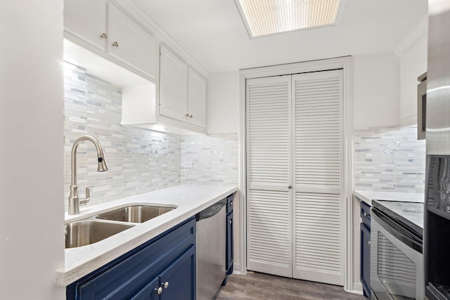 kitchen with sink, dishwasher, white cabinetry, blue cabinets, and decorative backsplash