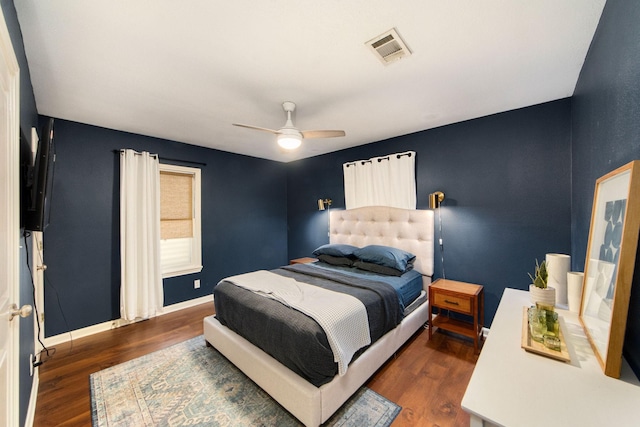 bedroom with ceiling fan and dark hardwood / wood-style flooring