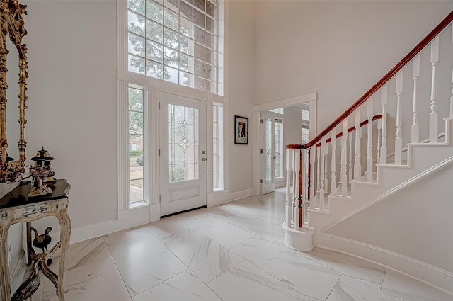 foyer entrance featuring a towering ceiling