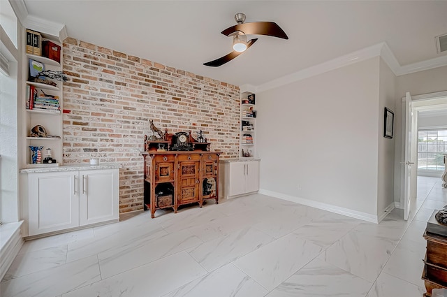 bar featuring white cabinetry, ceiling fan, brick wall, and crown molding