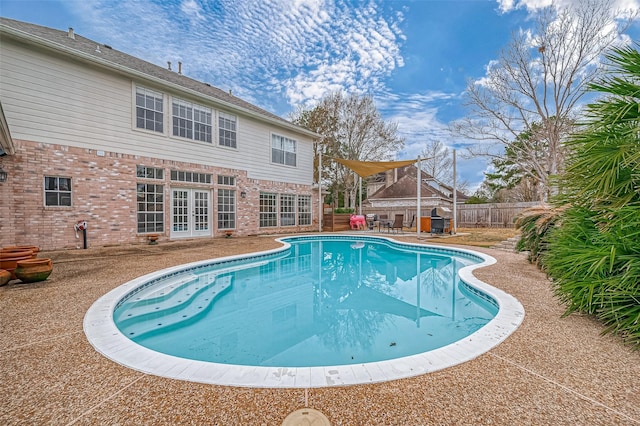 view of swimming pool featuring a patio and french doors