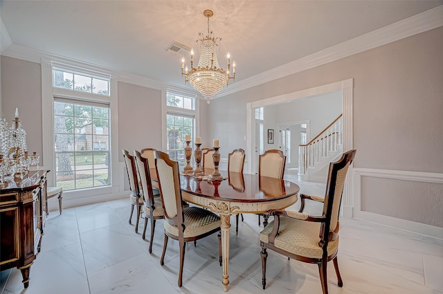 dining space with crown molding and a chandelier