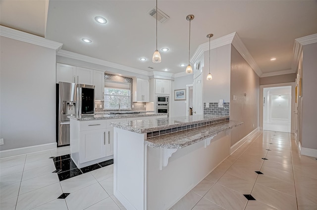 kitchen featuring appliances with stainless steel finishes, decorative light fixtures, white cabinetry, light tile patterned floors, and kitchen peninsula