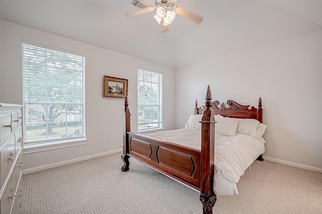 bedroom with multiple windows, light colored carpet, and ceiling fan