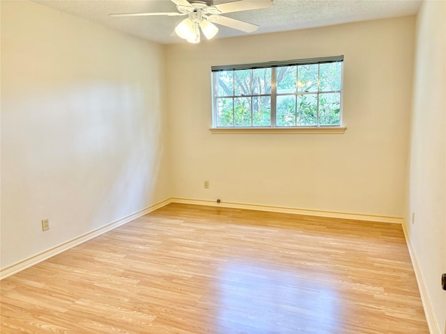 unfurnished room featuring a textured ceiling, ceiling fan, and light wood-type flooring