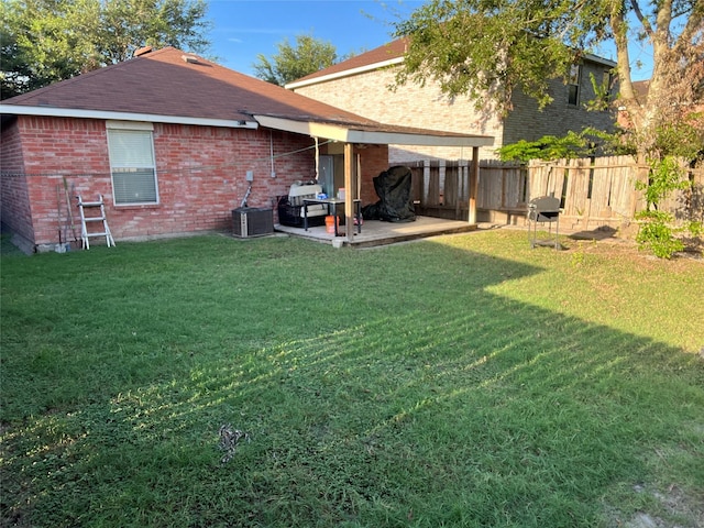 rear view of property with a yard and a patio