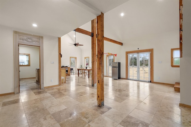 empty room featuring high vaulted ceiling and ceiling fan